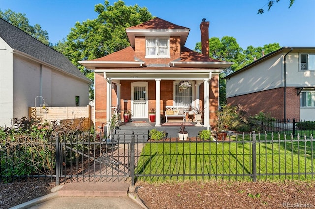 3016 N Franklin St, Denver, CO 80205 - view of front of house with covered porch, brick siding, a fenced front yard, a chimney, and a gate