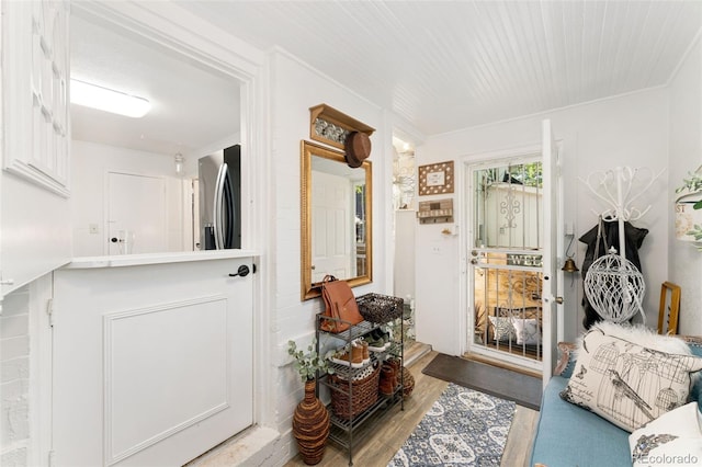 3016 N Franklin St, Denver, CO 80205 - doorway to outside featuring wood finished floors and crown molding