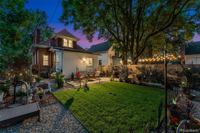 3016 N Franklin St, Denver, CO 80205 - back of house at dusk with a patio and a chimney