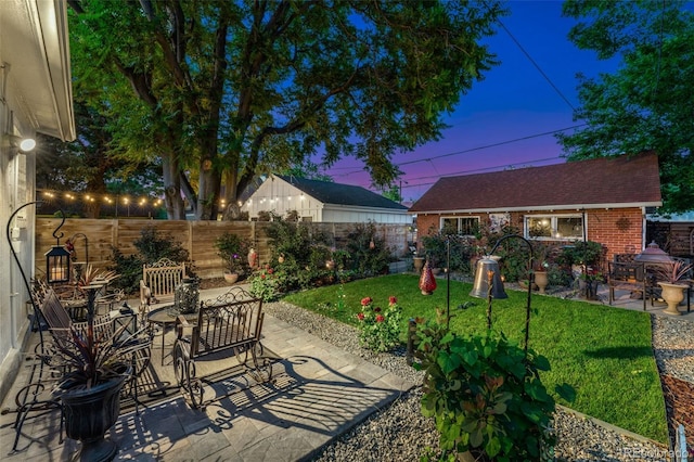 3016 N Franklin St, Denver, CO 80205 - patio terrace at dusk featuring a patio and a fenced backyard