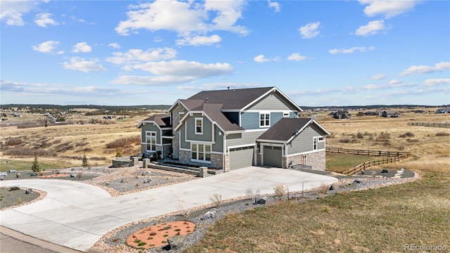 view of front of house with a rural view and a garage