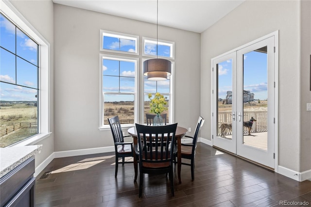 dining area featuring dark hardwood / wood-style floors, french doors, and a healthy amount of sunlight