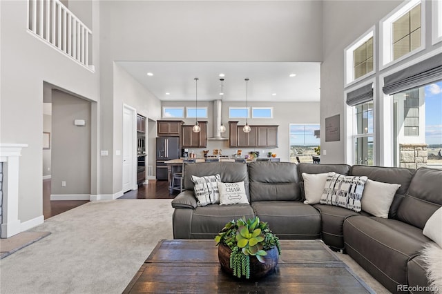 living room with a towering ceiling and dark wood-type flooring