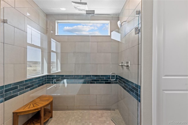 bathroom with tile walls and plus walk in shower