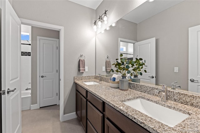 bathroom with tile flooring, double sink vanity, and a healthy amount of sunlight