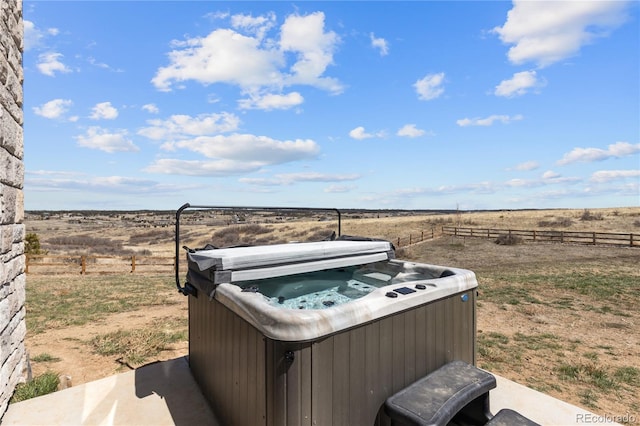 exterior space with a rural view and a hot tub