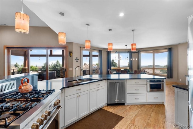 6170 Falcon Ridge Ln, Morrison, CO 80465 - kitchen with stainless steel appliances, white cabinetry, plenty of natural light, pendant lighting, and recessed lighting