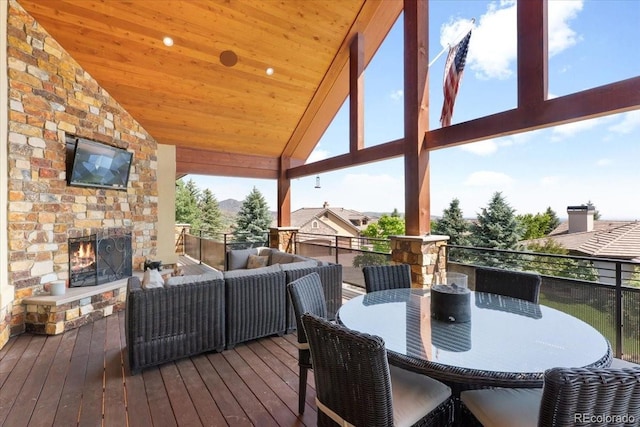 6170 Falcon Ridge Ln, Morrison, CO 80465 - deck featuring an outdoor living space with a fireplace and outdoor dining space