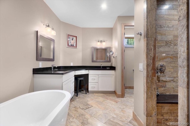 6170 Falcon Ridge Ln, Morrison, CO 80465 - full bathroom featuring a freestanding tub, double vanity, and walk in shower