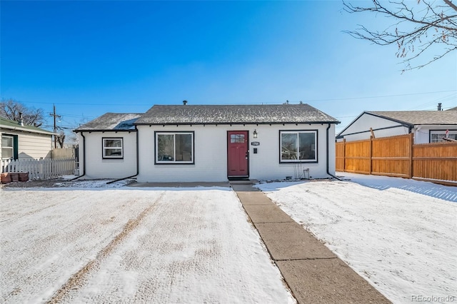 view of front of property with fence and brick siding