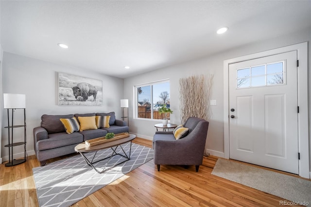 living area featuring recessed lighting, baseboards, and wood finished floors