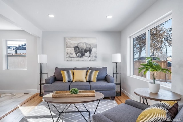 living room featuring recessed lighting, wood finished floors, and baseboards