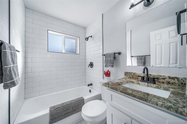 bathroom featuring toilet, tub / shower combination, and vanity