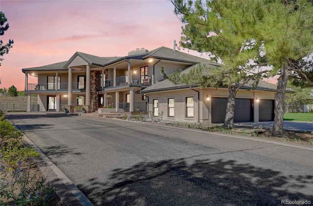 view of front facade featuring a garage and a balcony