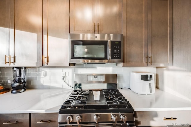 kitchen featuring appliances with stainless steel finishes and tasteful backsplash