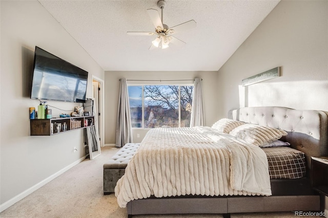 carpeted bedroom with ceiling fan, lofted ceiling, and a textured ceiling