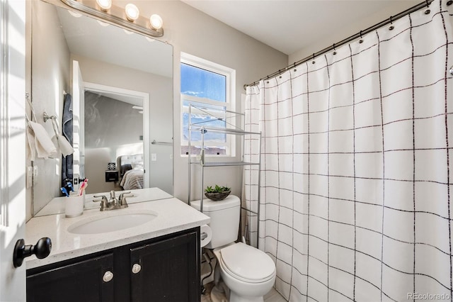 bathroom featuring vanity, toilet, and curtained shower