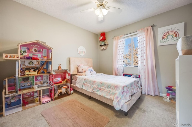 bedroom featuring ceiling fan, carpet floors, and a textured ceiling