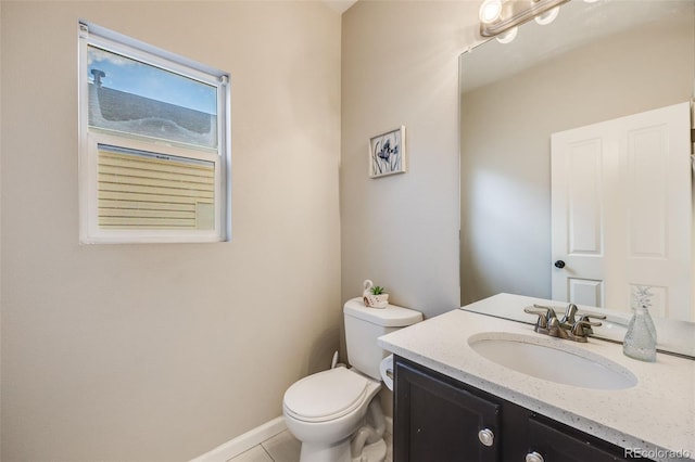 bathroom featuring tile patterned flooring, vanity, and toilet