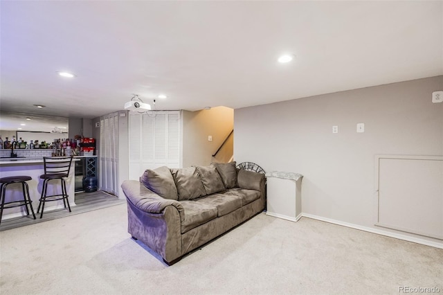 living room with light colored carpet and bar