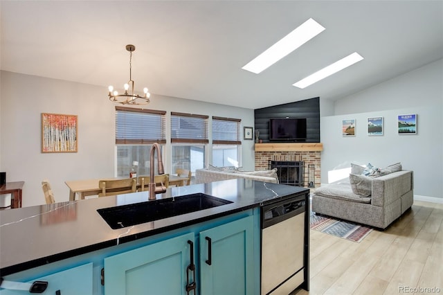 kitchen with dishwashing machine, a chandelier, a sink, dark countertops, and light wood-style floors