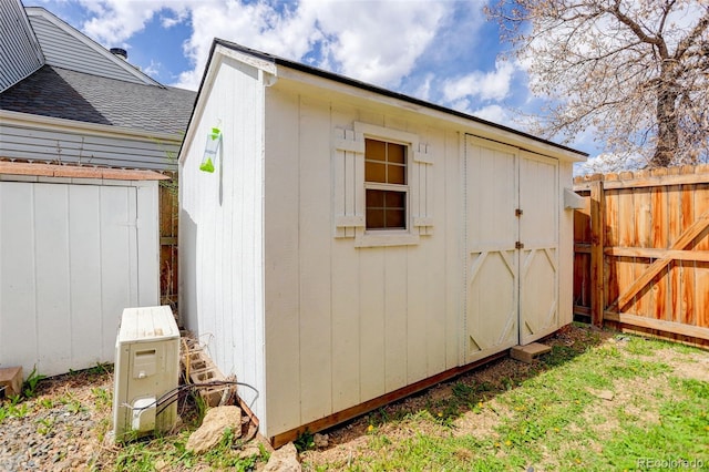 view of shed with fence