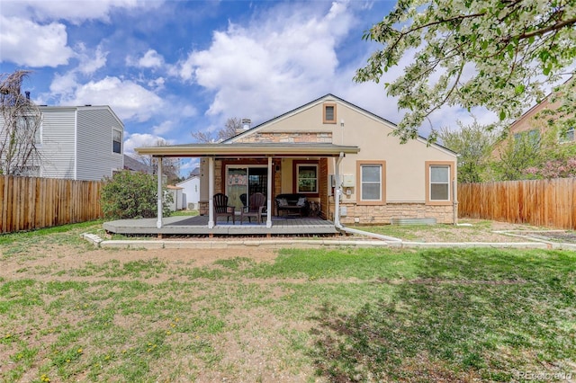 back of house with stone siding, a wooden deck, and stucco siding
