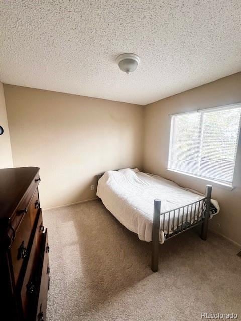 21030 E 39th Ave, Denver, CO 80249 - carpeted bedroom with a textured ceiling and baseboards