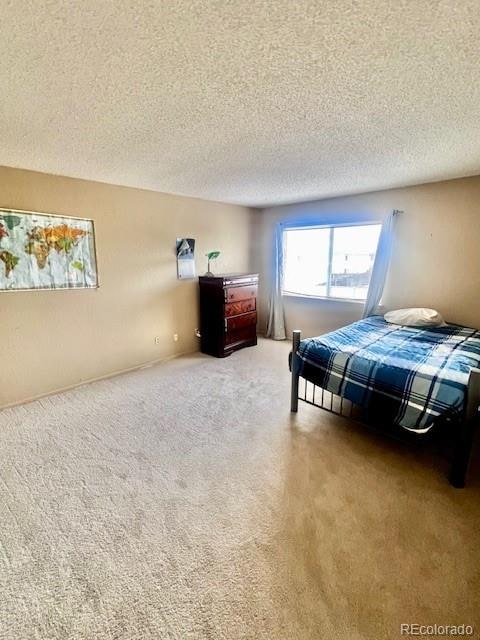 carpeted bedroom featuring a textured ceiling