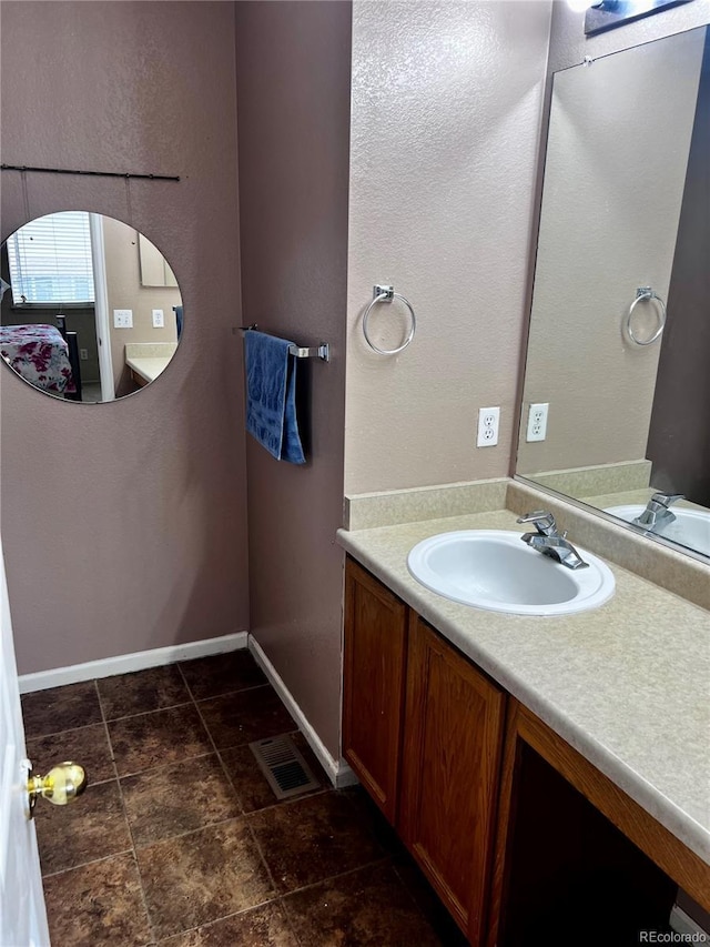 21030 E 39th Ave, Denver, CO 80249 - bathroom featuring visible vents, vanity, and baseboards
