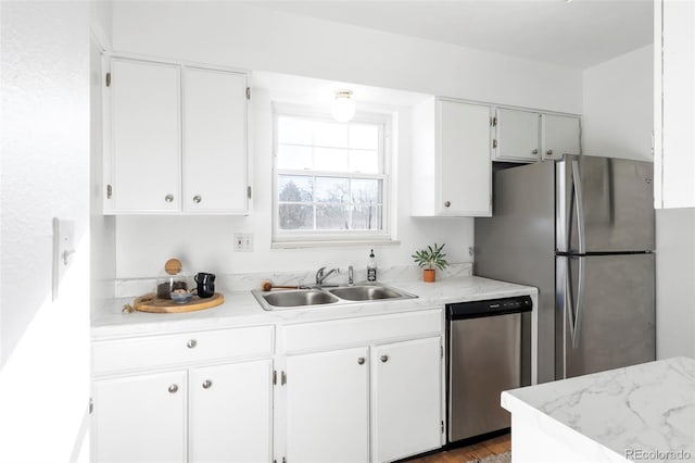 kitchen featuring white cabinetry, appliances with stainless steel finishes, and a sink