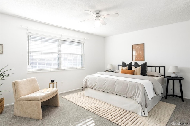 carpeted bedroom with a ceiling fan, baseboards, and a textured ceiling