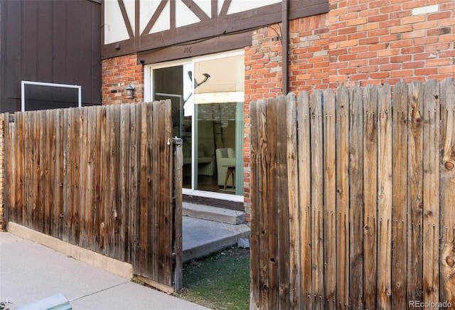 doorway to property featuring brick siding