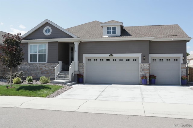 craftsman house featuring stone siding, concrete driveway, roof with shingles, and an attached garage