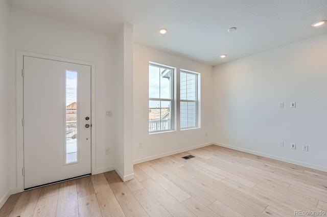 entryway with light hardwood / wood-style floors