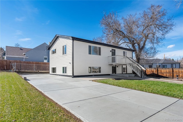 back of house featuring stairs, a patio, a yard, and fence