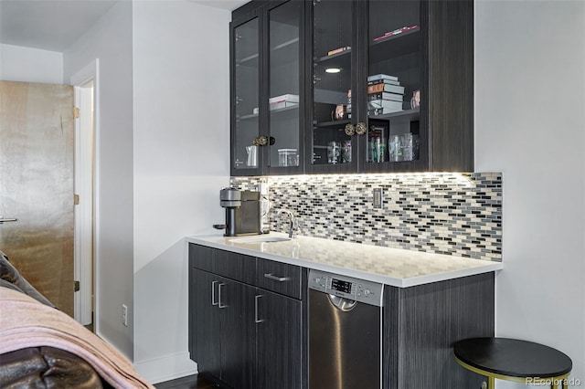 3444 Navajo St Unit 10, Denver, CO 80211 - bar featuring dishwasher, a sink, backsplash, and baseboards