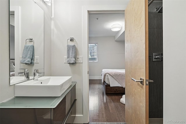 3444 Navajo St Unit 10, Denver, CO 80211 - bathroom featuring wood finished floors, vanity, ensuite bathroom, and baseboards