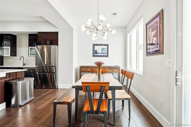 3444 Navajo St Unit 10, Denver, CO 80211 - dining room with a chandelier, dark wood-style flooring, and baseboards