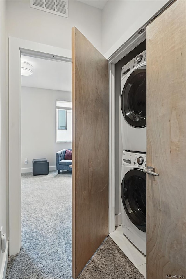 3444 Navajo St Unit 10, Denver, CO 80211 - laundry area with estacked washer and dryer, carpet floors, and baseboards