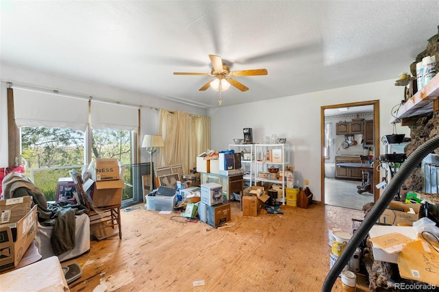 miscellaneous room featuring a ceiling fan and wood finished floors