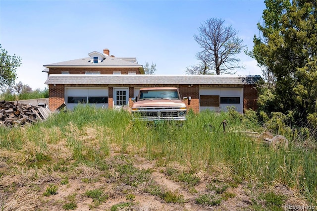 rear view of house featuring brick siding