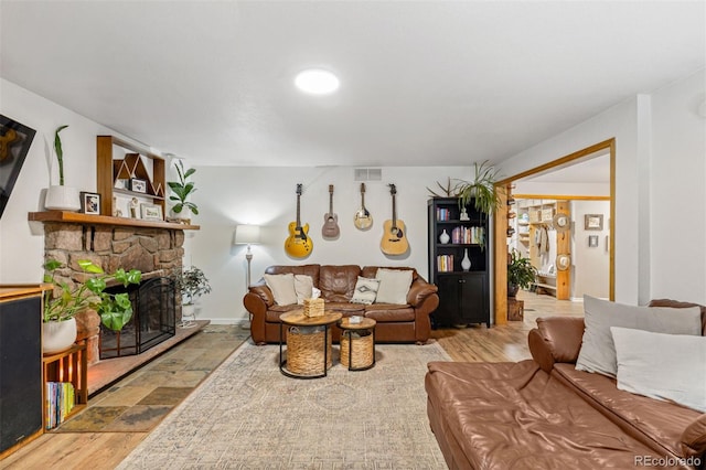 26095 Columbine Trl, Kittredge, CO 80457 - living room with wood finished floors, a fireplace, and visible vents