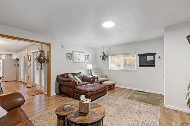 26095 Columbine Trl, Kittredge, CO 80457 - living room featuring baseboards, visible vents, a textured ceiling, and wood finished floors