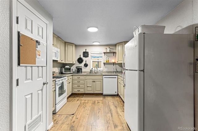 26095 Columbine Trl, Kittredge, CO 80457 - kitchen with a sink, light wood-style flooring, cream cabinets, white appliances, and visible vents