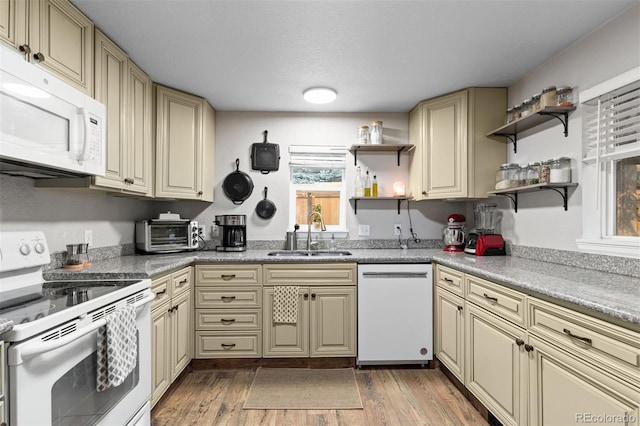 26095 Columbine Trl, Kittredge, CO 80457 - kitchen featuring a sink, open shelves, light wood-type flooring, cream cabinets, and white appliances