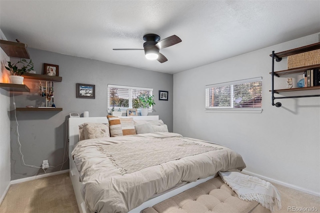 26095 Columbine Trl, Kittredge, CO 80457 - carpeted bedroom featuring multiple windows, ceiling fan, baseboards, and a textured ceiling