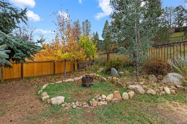 26095 Columbine Trl, Kittredge, CO 80457 - view of yard with a fenced backyard and a fire pit
