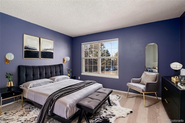 bedroom featuring a textured ceiling and carpet