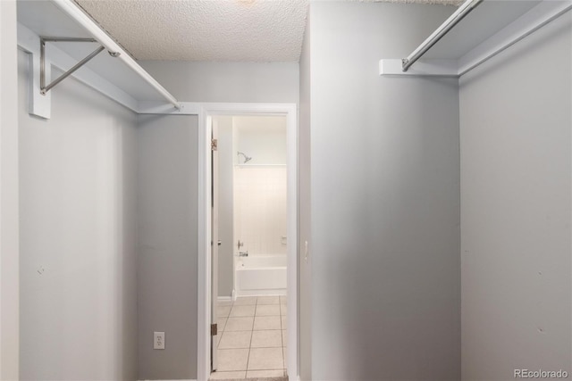 spacious closet with light tile patterned flooring